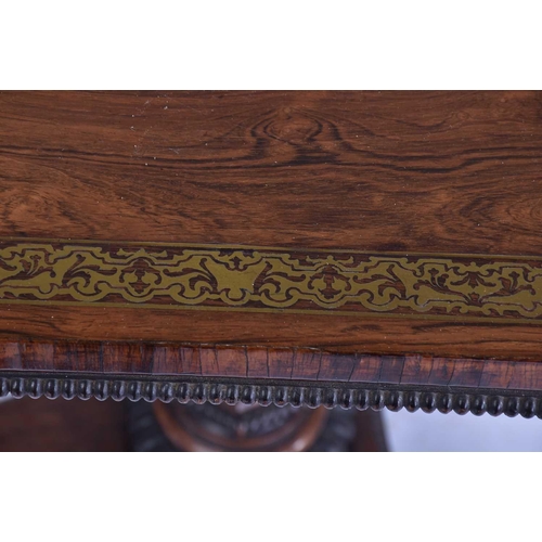 384 - A William IV rosewood and brass inlaid table, of rectangular form upon a tripartite base, with lions... 