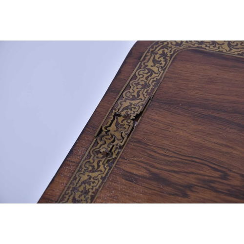 384 - A William IV rosewood and brass inlaid table, of rectangular form upon a tripartite base, with lions... 