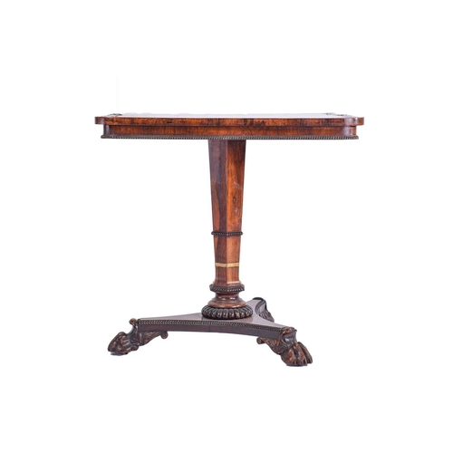 384 - A William IV rosewood and brass inlaid table, of rectangular form upon a tripartite base, with lions... 