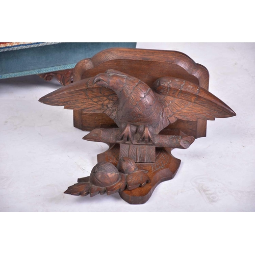 386 - A 19th-century naive carved oak wall bracket in the form of a perched spread eagle. 46 cm wide x 42 ... 