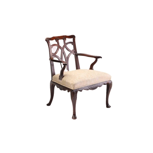 393 - A George II provincial red walnut and mahogany open armchair with shaped and carved cresting above a... 