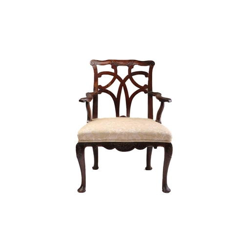 393 - A George II provincial red walnut and mahogany open armchair with shaped and carved cresting above a... 