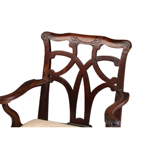 393 - A George II provincial red walnut and mahogany open armchair with shaped and carved cresting above a... 