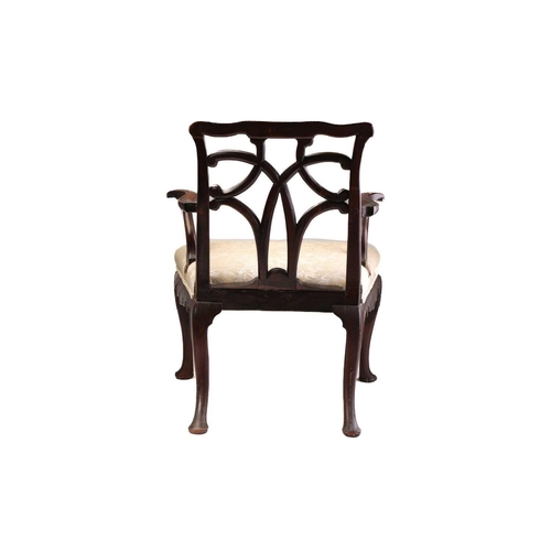 393 - A George II provincial red walnut and mahogany open armchair with shaped and carved cresting above a... 