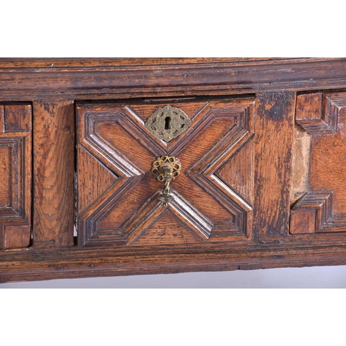 395 - A Charles II three drawer oak dresser base. Fitted three geometrically moulded deep drawers, on turn... 