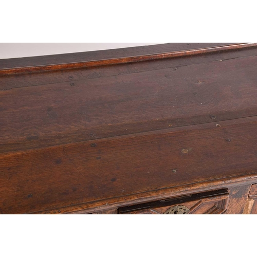 395 - A Charles II three drawer oak dresser base. Fitted three geometrically moulded deep drawers, on turn... 