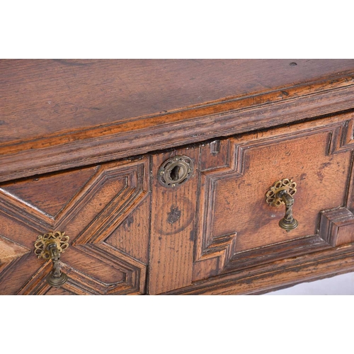 395 - A Charles II three drawer oak dresser base. Fitted three geometrically moulded deep drawers, on turn... 