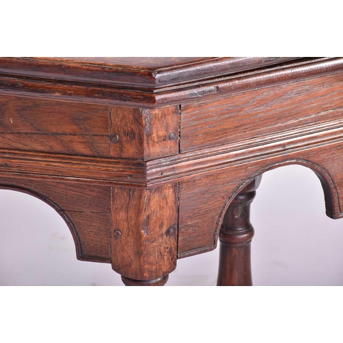 399 - An early 17th-century style oak credence table with a planked fold-over top and hinged support With ... 