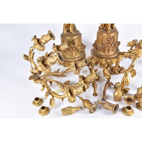 401 - A pair of large French 19th century figural bronze candelabras, in the form of cherubs on a column p... 