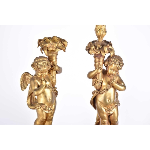 401 - A pair of large French 19th century figural bronze candelabras, in the form of cherubs on a column p... 