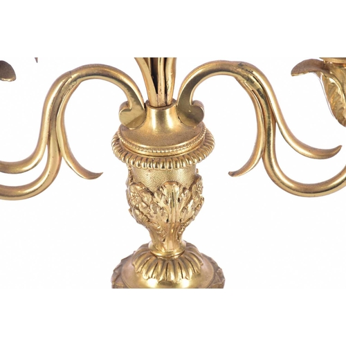 408 - A pair of gilt matel three branch candelabra, late 19th/arly 20th century, the branches terminating ... 