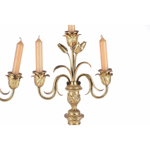 408 - A pair of gilt matel three branch candelabra, late 19th/arly 20th century, the branches terminating ... 