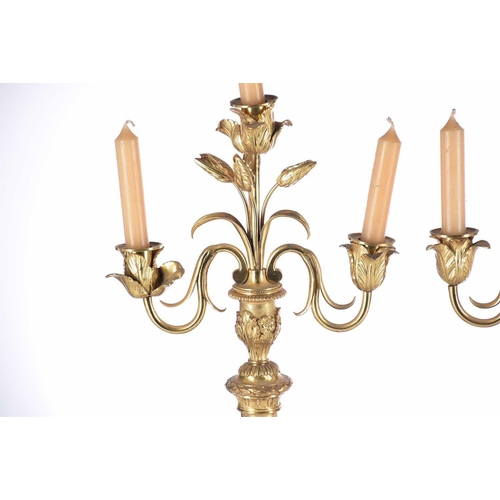 408 - A pair of gilt matel three branch candelabra, late 19th/arly 20th century, the branches terminating ... 