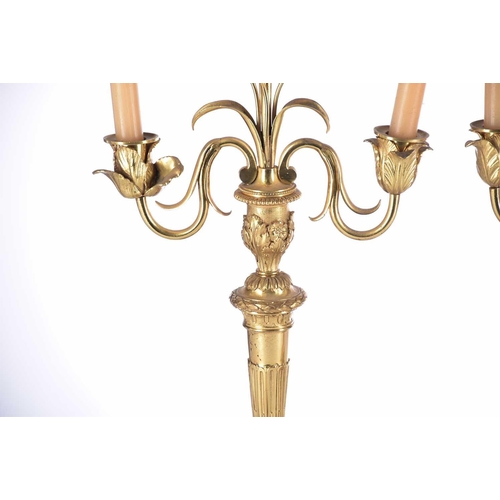 408 - A pair of gilt matel three branch candelabra, late 19th/arly 20th century, the branches terminating ... 