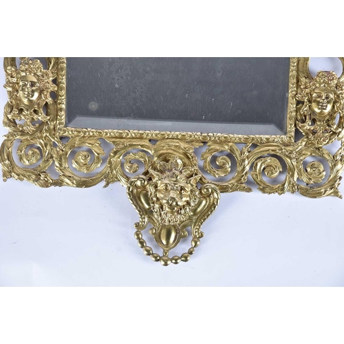 411 - A Victorian cast and gilt brass wall mirror with Vitruvian scroll border and Athene and satyr mask d... 