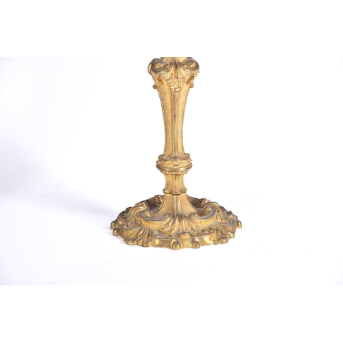 412 - A pair of gilt metal three branch candelabra, late 19th/early 20th century, in the rococo style with... 