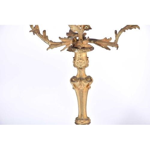 412 - A pair of gilt metal three branch candelabra, late 19th/early 20th century, in the rococo style with... 