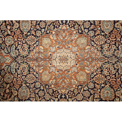 414 - A 20th-century large Persian silk mix Qum style carpet with a central lozenge with scrolling flowers... 