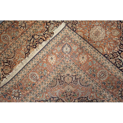 414 - A 20th-century large Persian silk mix Qum style carpet with a central lozenge with scrolling flowers... 