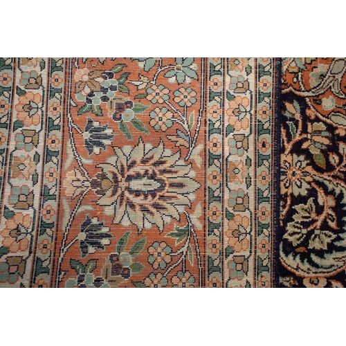 414 - A 20th-century large Persian silk mix Qum style carpet with a central lozenge with scrolling flowers... 