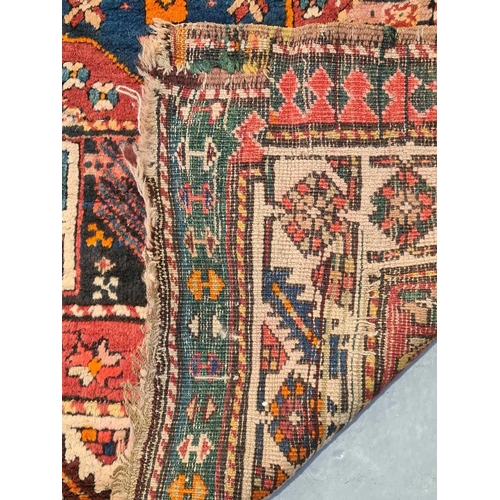 417 - An indigo blue ground Karachov Kazak long rug, first half of the 20th century, with four geometric l... 