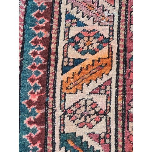 417 - An indigo blue ground Karachov Kazak long rug, first half of the 20th century, with four geometric l... 