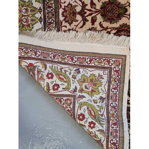 420 - An Indian (Kashmiri) ivory ground silk on silk rug with red and pistachio green palmette and 