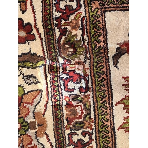 420 - An Indian (Kashmiri) ivory ground silk on silk rug with red and pistachio green palmette and 