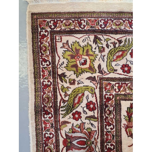 420 - An Indian (Kashmiri) ivory ground silk on silk rug with red and pistachio green palmette and 