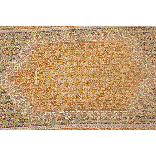 422 - An ochre ground Turkish silk Kelim rug with a large central lozenge filled with geometric designs wi... 