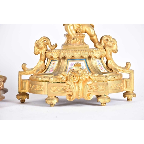 435 - A matched gilt metal clock garniture, 19th century, each with Paris porcelain panels, the clock with... 