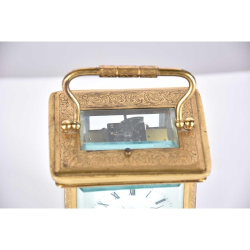 445 - A large brass cased carriage clock, late 19th century, the enamel dial with roman numerals and subsi... 