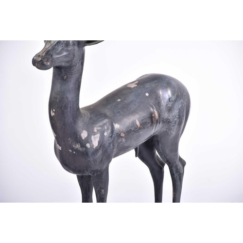 452 - A pair of Art Deco style patinated figures of deer, 20th century, on simple rectangular hollow bases... 