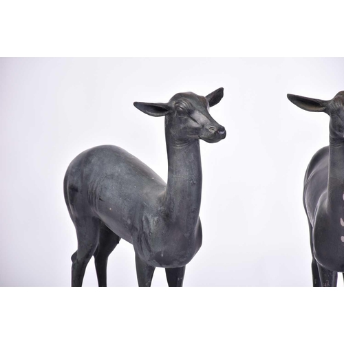 452 - A pair of Art Deco style patinated figures of deer, 20th century, on simple rectangular hollow bases... 