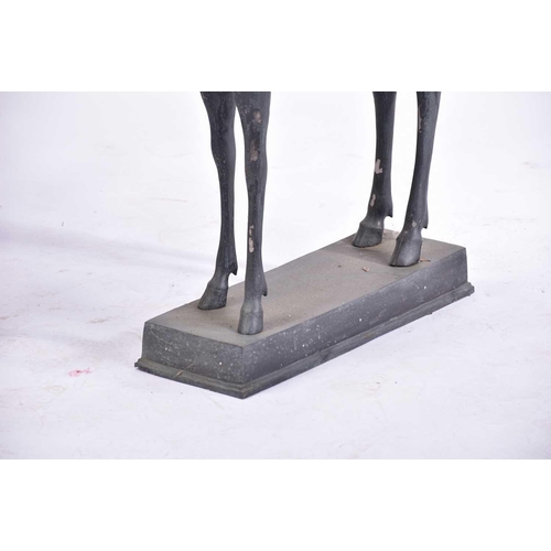 452 - A pair of Art Deco style patinated figures of deer, 20th century, on simple rectangular hollow bases... 