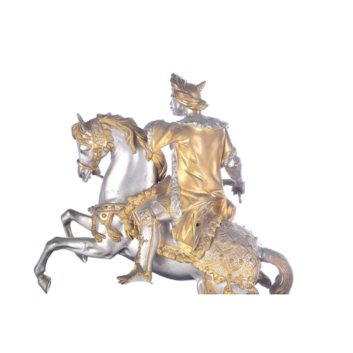 471 - A pair of parcel gilt and silvered metal equestrian warrior figures, 20th century, modelled as a med... 