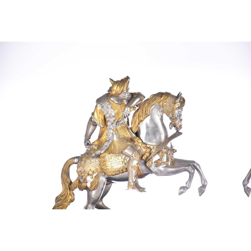 471 - A pair of parcel gilt and silvered metal equestrian warrior figures, 20th century, modelled as a med... 