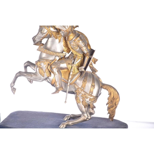 471 - A pair of parcel gilt and silvered metal equestrian warrior figures, 20th century, modelled as a med... 