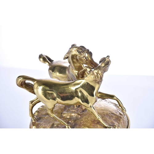 474 - A mid 19th century gilt bronze oversized desk inkwell, the cover with two fighting wild horses, the ... 