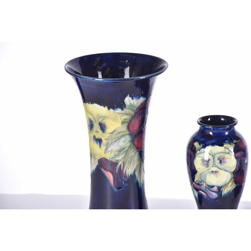 485 - Four items of Moorcroft, comprising a large pansy vase, another smaller pansy vase, a small pedestal... 