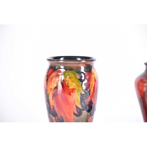 488 - A 20th Century Moorcroft flambe wisteria vase and a Moorcroft flambe leaf & berries vase, both signe... 