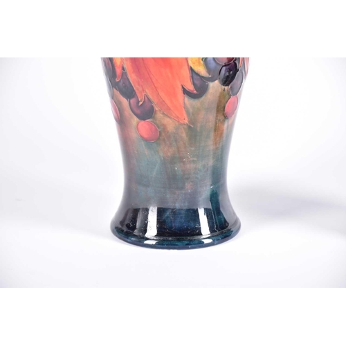 488 - A 20th Century Moorcroft flambe wisteria vase and a Moorcroft flambe leaf & berries vase, both signe... 