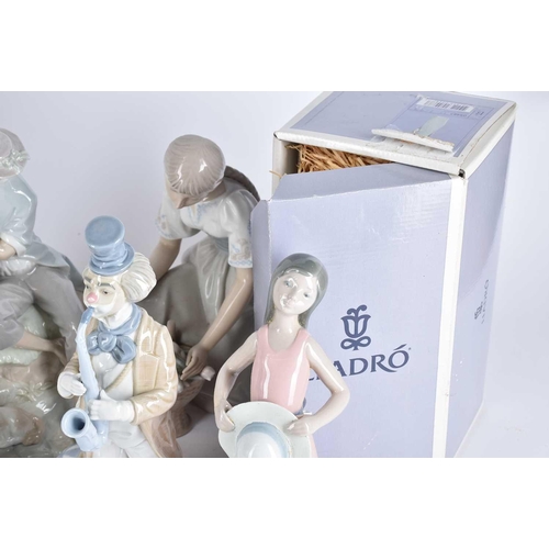 498 - A collection of Lladro and Requena porcelain figures, to include two lovers eating grapes before a t... 