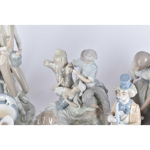 498 - A collection of Lladro and Requena porcelain figures, to include two lovers eating grapes before a t... 