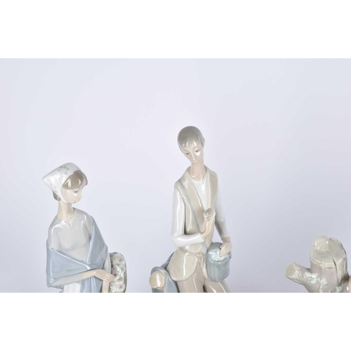 498 - A collection of Lladro and Requena porcelain figures, to include two lovers eating grapes before a t... 