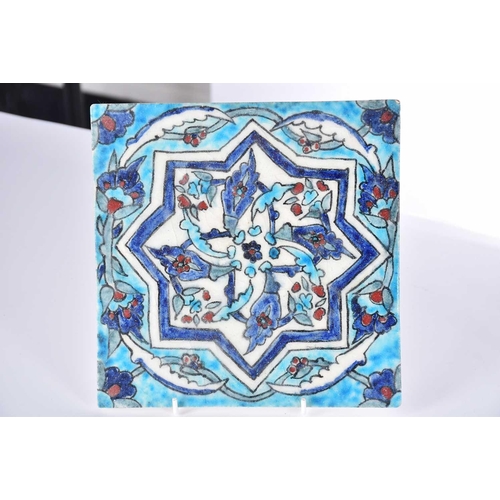 510 - A group of five Iznik-style items consists of three tiles, the largest 25cm square, the smallest til... 