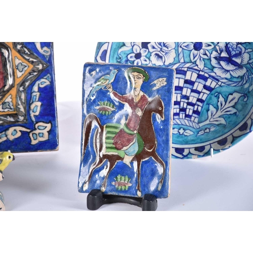 510 - A group of five Iznik-style items consists of three tiles, the largest 25cm square, the smallest til... 