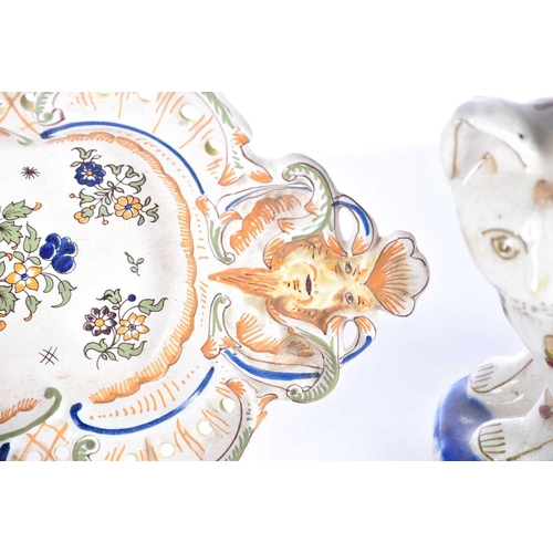 515 - A collection of seven items of continental ceramics including a delftware vase, faience ware cat, an... 