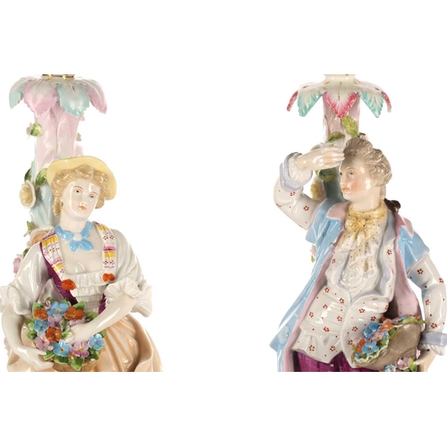 524 - A pair of Continental porcelain figural candlesticks, late 19th century, possibly Volkstedt, mounted... 