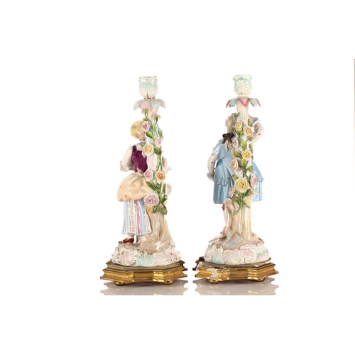 524 - A pair of Continental porcelain figural candlesticks, late 19th century, possibly Volkstedt, mounted... 